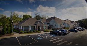 Greenville apartment for rent - A parking lot in front of a building with cars parked.