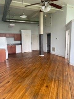 Madison Heights apartment for rent - A room with wooden floors and a ceiling fan.