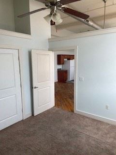 Madison Heights apartment for rent - A room with a ceiling fan and two doors.