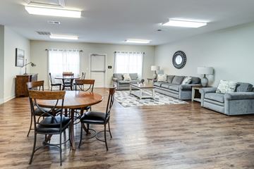 Newport News apartment for rent - A living room with a wooden table and chairs.