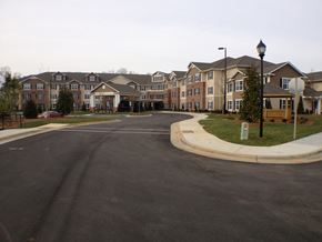 Concord apartment for rent - A street view of apartment buildings with a sidewalk and lamp post.