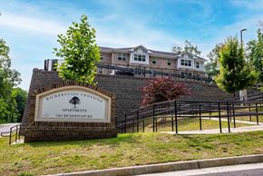 Henrico apartment for rent - A sign for Bickerstaff Crossing Apartments stands in front of a brick wall. at Bickerstaff Crossing Apartments, Henrico, VA