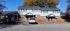 Centreville apartment for rent - A two-story house with a white car parked in front.