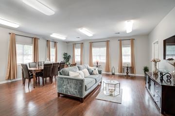 Concord apartment for rent - A living room with a grey couch and wooden floors.