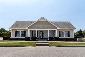 Lumberton apartment for rent - A small white house with a black front door and two windows at Carriage Hills, 28358