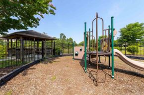Rolesville apartment for rent - A playground with a slide, swings, and a gazebo at Granite Falls Apartments, Rolesville, NC, 27571