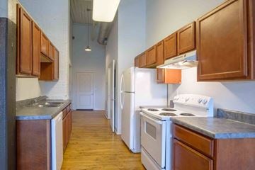 Lynchburg apartment for rent - A kitchen with wooden cabinets and white appliances.