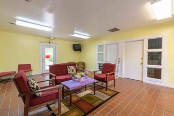 Kinston apartment for rent - A living room with a purple table and red chairs.