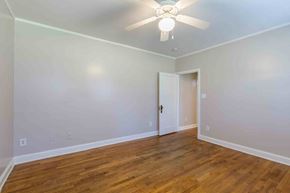 Kinston apartment for rent - A room with a ceiling fan and wooden floors.at Kinston Oaks Apartments, Kinston, NC 28501