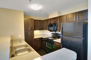Gastonia apartment for rent - Kitchen with a sink, stove, and refrigerator at Highland Memorial, Gastonia, 28052