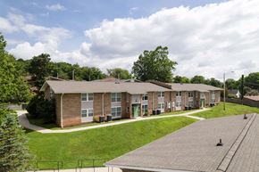 Marion apartment for rent - Apartment complex with a green lawn in front.