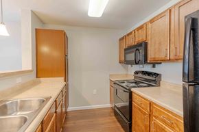 Charleston condo for rent - A kitchen with wooden cabinets and stainless steel appliances.at Marsh View Place, Charleston, SC