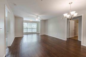 Charleston condo for rent - A spacious room with wooden floors and a ceiling fan.at Marsh View Place, Charleston, SC 29455