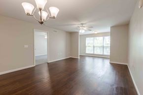 Charleston condo for rent - A room with wooden floors and a chandelier.at Marsh View Place, Charleston