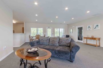 Charleston condo for rent - A living room with a grey couch and a wooden coffee table.