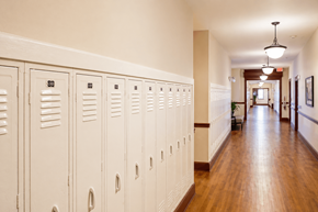 Cramerton apartment for rent - A long hallway with white lockers on the side.