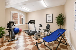 Cramerton apartment for rent - A room with exercise equipment and a blue folding chair.