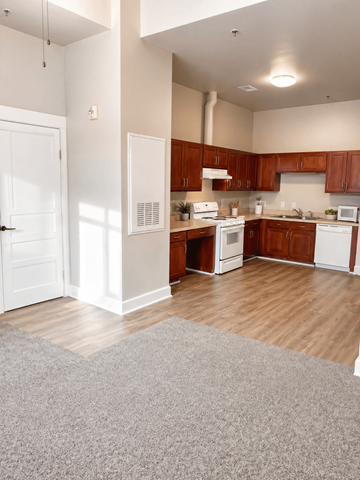 Cramerton apartment for rent - A kitchen with white appliances and wooden cabinets.