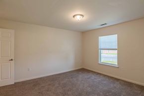 Staunton apartment for rent - A room with a carpeted floor, a window, and a door. at Mountain Laurel III Apartments, Staunton, Virginia
