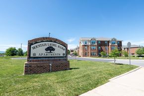Staunton apartment for rent - A sign for Mountain Laurel Manor Apartments stands in front of a building. at Mountain Laurel III Apartments, Staunton, VA, 24401