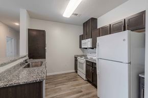 Savannah apartment for rent - A kitchen with a white refrigerator, white oven, and white microwave. at Ogeechee Place, Savannah, 31405