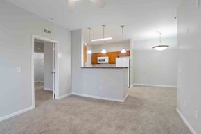 Greenville apartment for rent - A spacious room with a kitchenette and a ceiling fan.