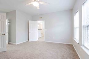 Greenville apartment for rent - A room with a ceiling fan and carpeted floor.