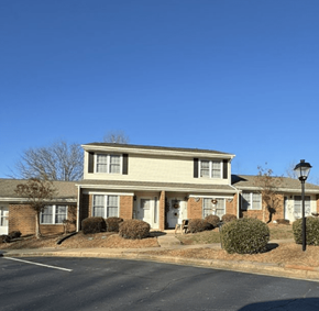 Shelby apartment for rent - A residential building with a parking lot in front.
