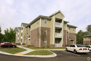 Summerville apartment for rent - A large apartment building with a parking lot in front.at Summerville Garden, Summerville South Carolina