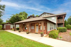 Marion apartment for rent - A house with a green lawn and a brown roof.