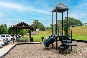 Marion apartment for rent - A playground with a green slide and a wooden structure.