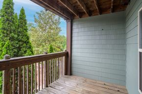 Marion apartment for rent - A wooden deck with a railing and a view of trees.