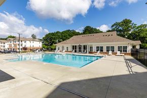 Stonecrest apartment for rent - A large swimming pool with a building behind it.