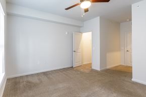 Stonecrest apartment for rent - A room with a ceiling fan and carpeted floor.