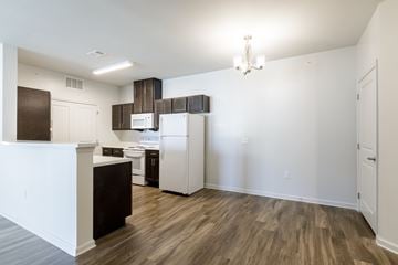Stonecrest apartment for rent - A kitchen with white appliances and wood floors.