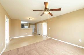 Rolesville apartment for rent - A spacious room with a ceiling fan and carpeted floor. at The Grande at Granite Falls LLC Apartments, Rolesville, NC