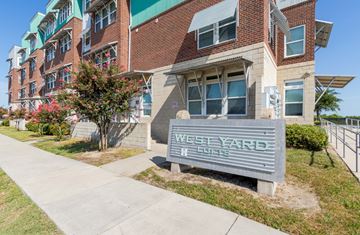 North Charlston apartment for rent - A sign that says West Yarde stands in front of a building.