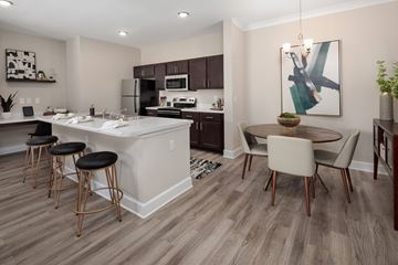 Summerville apartment for rent - A modern kitchen with a bar area and a dining table.