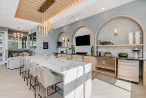 Parker apartment for rent - A modern kitchen with a long white table and chairs.