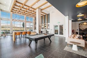 Parker apartment for rent - A spacious room with a pool table and a view of the outdoors.