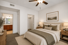 Phoenix apartment for rent - A bedroom with a large bed and a ceiling fan.