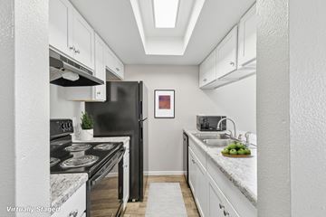 Tempe apartment for rent - A kitchen with a black stove top oven and a black refrigerator.