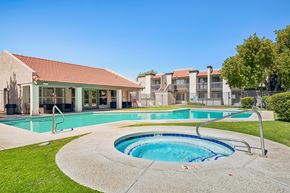Glendale apartment for rent - A swimming pool with a hot tub in the middle of it.