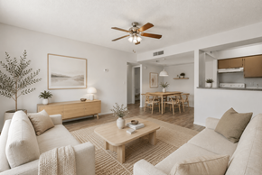 Glendale apartment for rent - A living room with a beige couch, a coffee table, and a ceiling fan.