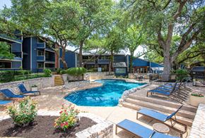 Austin apartment for rent - A pool surrounded by trees and chairs.