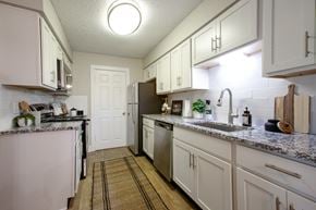 Hendersonville apartment for rent - A kitchen with white cabinets and a granite countertop.