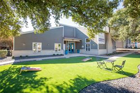 San Antonio apartment for rent - A building with a blue door and a sign that says "Welcome to our new community center".