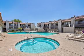 Glendale apartment for rent - A swimming pool in a residential area with a clear blue sky.