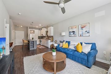 Charlotte apartment for rent - A living room with a blue couch and a coffee table.
