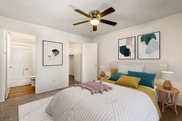 Mesa apartment for rent - A bedroom with a large bed and a ceiling fan.